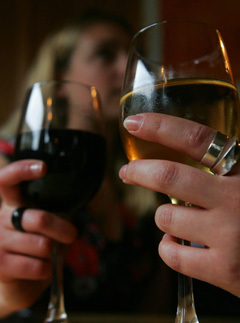 Two females drink wine in a central London pub