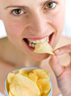 Woman eating crisps