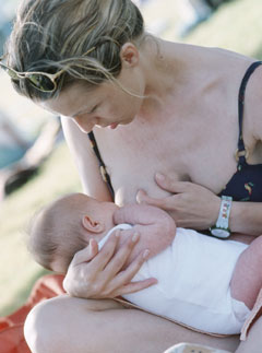 Marie Claire Health News: Woman Breast Feeding a Child
