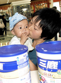 Marie Claire World News: Woman with baby - China milk scandal