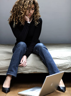 Sad woman with computer, dating, marie claire