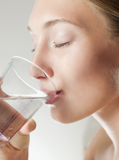 Woman drinks a glass of water - smart morning snacks - health