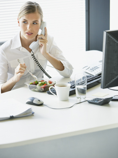 Woman eating lunch at desk