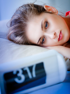 Woman not sleeping, Womin in bed, woman awake, woman looking at clock, tired woman