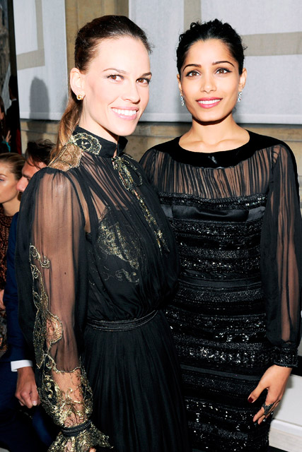 Hilary Swank and Freida Pinto garticle at the Salvatore Ferragamo Cruise Collection fashion show in Paris