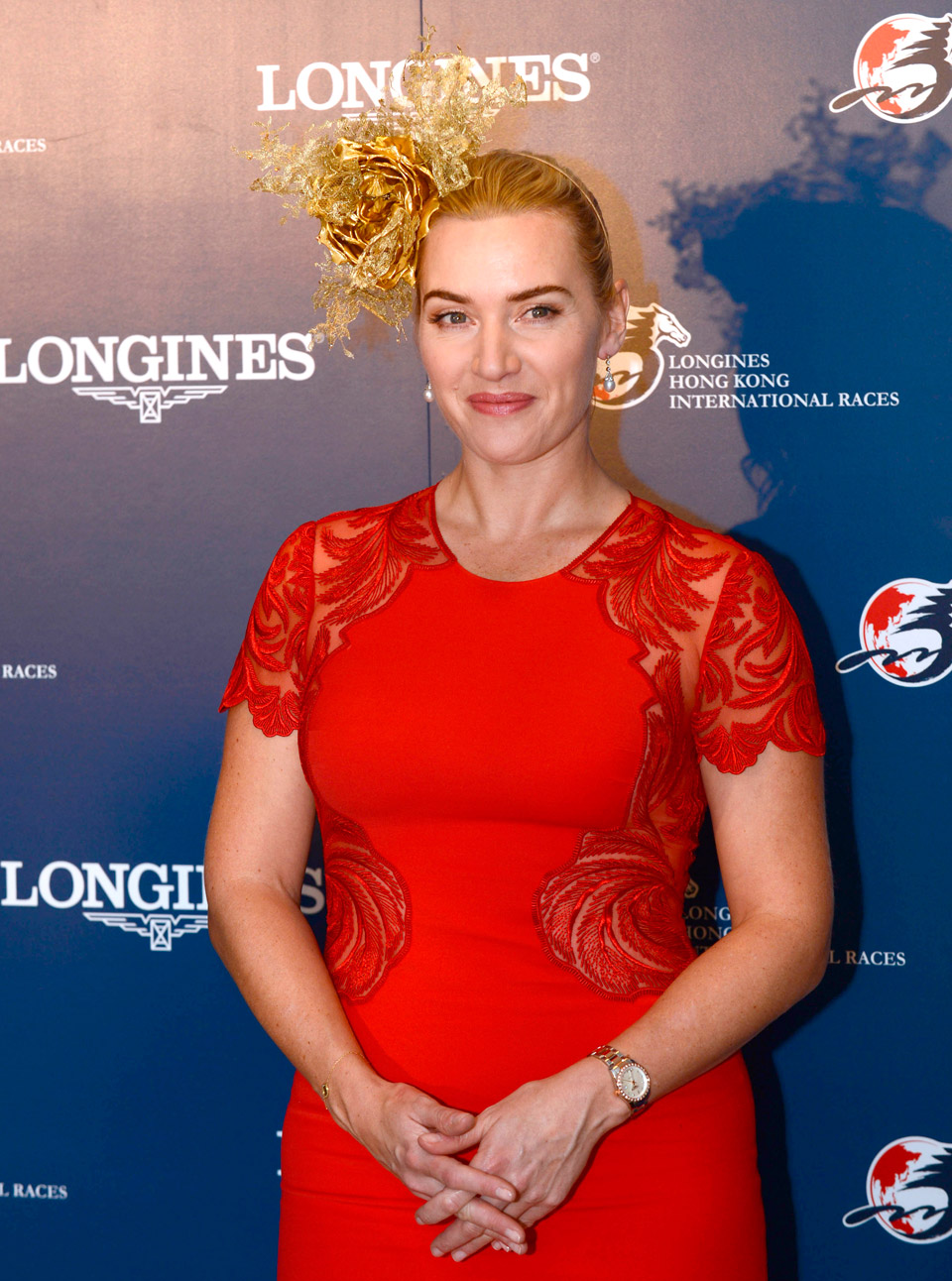 Kate Winslet wearing a red dress and fascinator at the Longines Hong Kong International Races