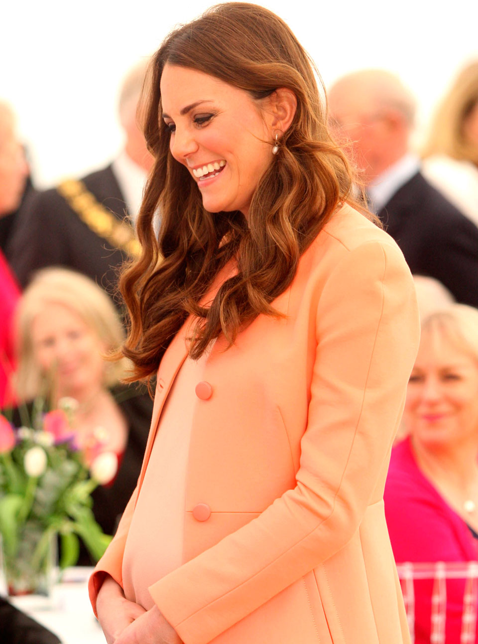 Kate Middleton wearing a coral coat