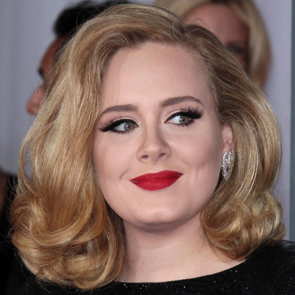 Adele looking gorgeous with high volume hair and a statement red lip