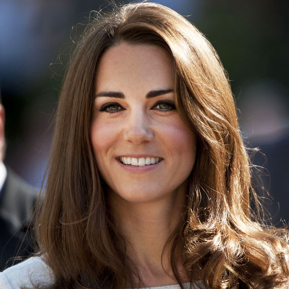 Kate Middleton looks radiant in a white dress with thick tumbling tresses and a rosy glow