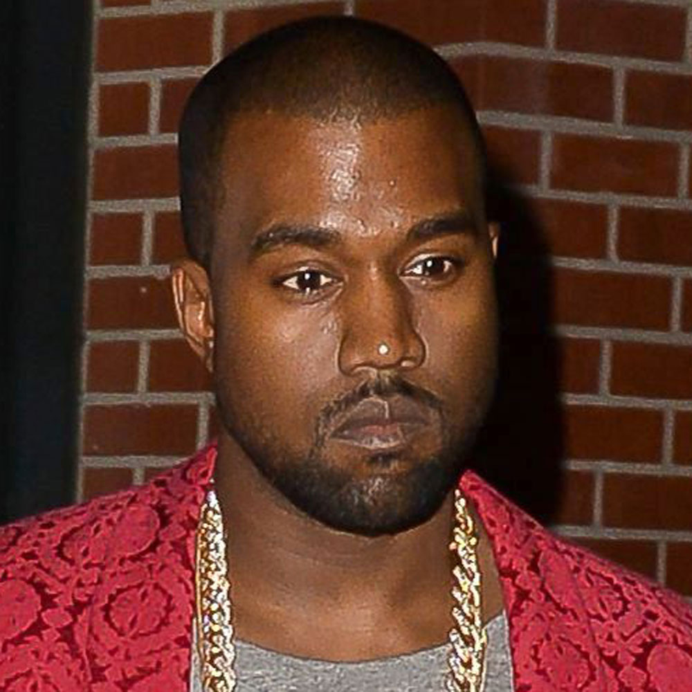 Kanye West out for dinner with Kim Kardashian in a grey tshirt and red blazer