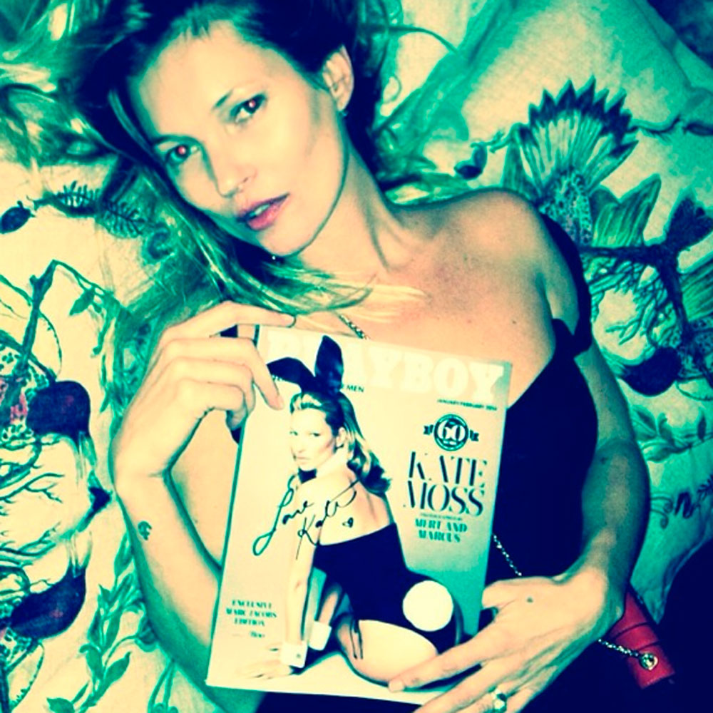 Kate Moss holds up a copy of her new Playboy cover
