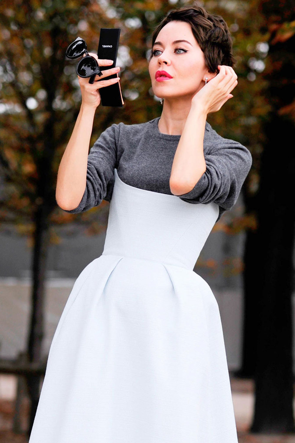A woman working a white day dresses with red lips