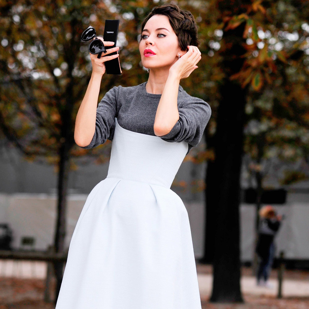 A woman working a white day dresses with red lips