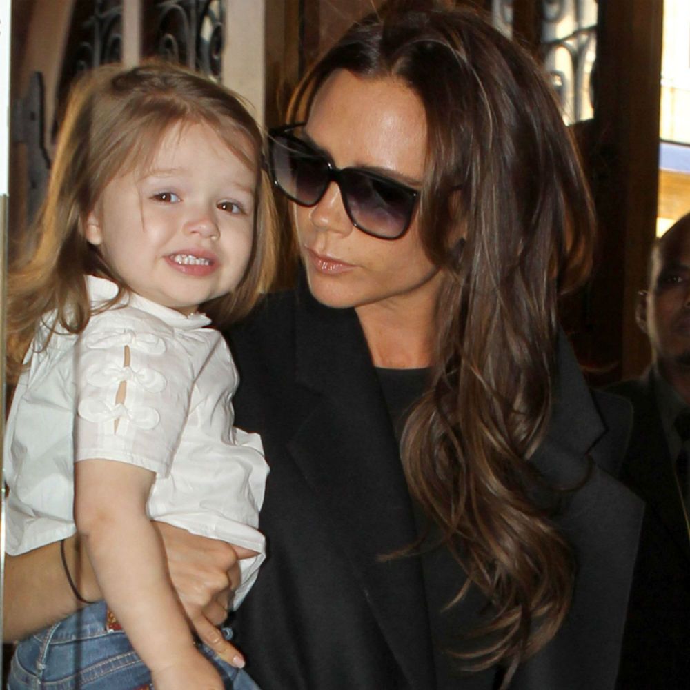 Victoria Beckham cuddles little Harper in London