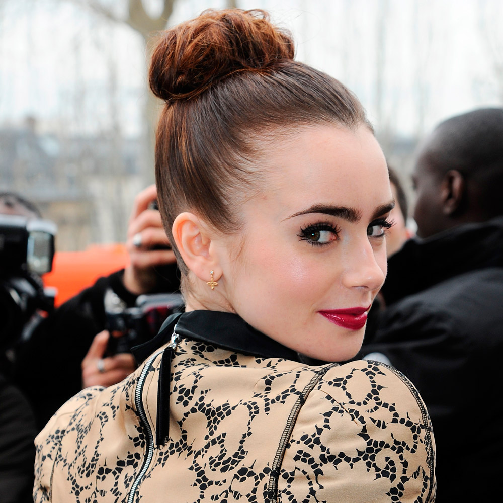 Lily Collins wearing a topknot hairstyle