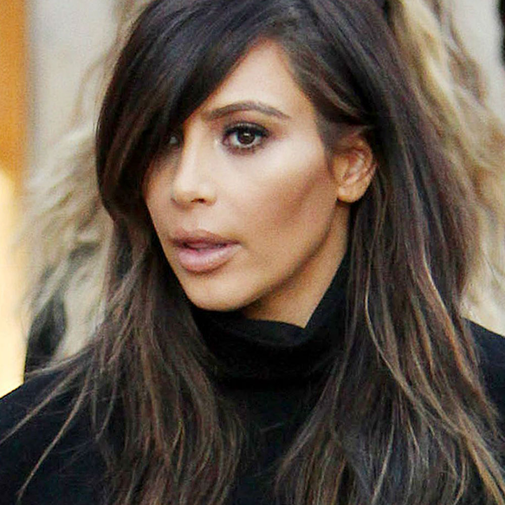 Kim Kardashian wears leather leggings boots.