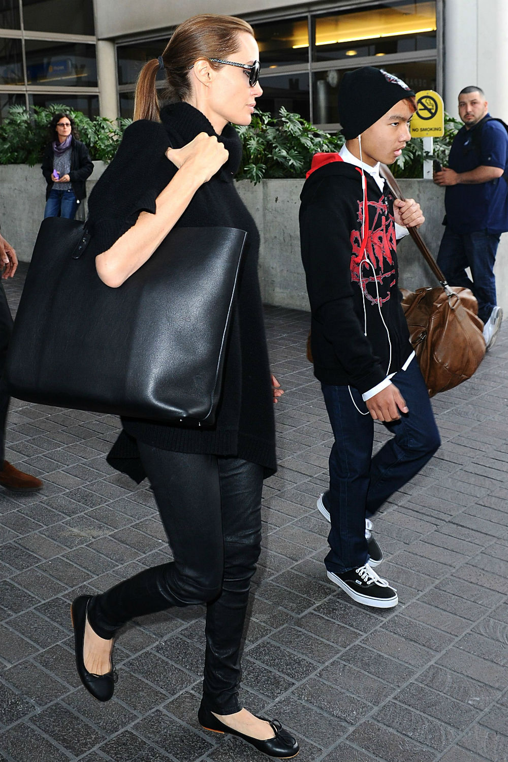 Angelina Jolie, Brad Pitt and Maddox arrive at LAX. Angelina Jolie, Brad Pitt and Maddox arrive at LAX.