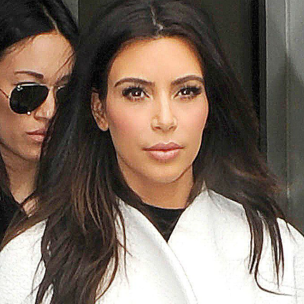 Kim Kardashian wears monochrome trend, see-through top.